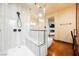 Bright bathroom featuring a glass-enclosed shower with bench and an elegant soaking tub at 479 Apogee, Mesquite, NV 89027
