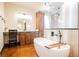 Spacious bathroom featuring a modern tub, wooden cabinetry, and a glass-enclosed shower at 479 Apogee, Mesquite, NV 89027