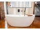 Freestanding tub with black fixtures is a focal point in this luxurious bathroom at 479 Apogee, Mesquite, NV 89027