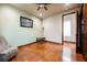 Bedroom with neutral walls, brown flooring, a modern ceiling fan and a comfortable, cozy chair at 479 Apogee, Mesquite, NV 89027