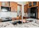 Kitchen showcasing marble island with sink, custom wood cabinets, stainless steel appliances and pantry at 479 Apogee, Mesquite, NV 89027