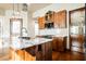Kitchen featuring marble island with sink, custom wood cabinets, and frosted pantry door at 479 Apogee, Mesquite, NV 89027