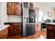 Bright kitchen featuring stainless steel refrigerator, custom wood cabinets, and marble countertops at 479 Apogee, Mesquite, NV 89027