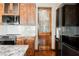Kitchen showcasing custom wood cabinets, stainless steel appliances, and frosted pantry door at 479 Apogee, Mesquite, NV 89027