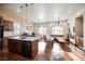 Open-concept floor plan with wood cabinetry, stainless steel appliances, and leather furniture at 479 Apogee, Mesquite, NV 89027