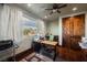 Home office featuring natural light, a ceiling fan, and custom wooden doors at 479 Apogee, Mesquite, NV 89027
