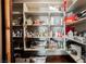 Pantry with shelving stocked with a variety of food items and household essentials at 479 Apogee, Mesquite, NV 89027