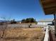 Expansive backyard view showcases mature trees, fence, and a glimpse of the house's exterior and covered porch at 5061 E Kellogg Rd, Pahrump, NV 89061