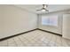 Bedroom featuring tiled floors, a modern ceiling fan, and a large window at 520 S 13Th St # D17, Las Vegas, NV 89101