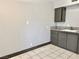 Galley kitchen featuring tiled flooring, neutral walls, and modern cabinets at 520 S 13Th St # D17, Las Vegas, NV 89101