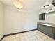 A well-lit kitchen featuring tile floors and gray cabinets at 520 S 13Th St # D17, Las Vegas, NV 89101