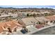 Aerial view of a home featuring a well-maintained lawn and desert landscaping and a two car garage at 580 Kenerly St, Henderson, NV 89015