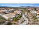 An aerial view of a quiet suburban neighborhood featuring walking trails and mountain views in the distance at 580 Kenerly St, Henderson, NV 89015