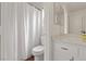 Well-lit bathroom with an updated vanity featuring a quartz countertop, wood-look floors, and shower at 580 Kenerly St, Henderson, NV 89015