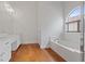 Bright bathroom with double sinks, a soaking tub, and a window at 580 Kenerly St, Henderson, NV 89015