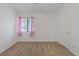 Clean bedroom with neutral carpet, a window with curtains, and a door on the right side of the frame at 580 Kenerly St, Henderson, NV 89015
