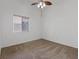 Spacious bedroom features neutral carpet, a window with blinds, and a ceiling fan for a comfortable atmosphere at 580 Kenerly St, Henderson, NV 89015