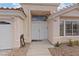 Inviting entrance with double doors, covered porch, and neutral exterior paint at 580 Kenerly St, Henderson, NV 89015