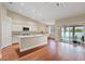 Open concept kitchen with granite countertops, stainless appliances, and hardwood flooring at 580 Kenerly St, Henderson, NV 89015