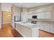 Bright kitchen with granite counters, stainless appliances, and hardwood floors at 580 Kenerly St, Henderson, NV 89015