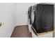 This laundry room features a front load washer and dryer set, with updated wood look tile flooring and a door to the outside at 580 Kenerly St, Henderson, NV 89015