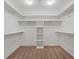 Spacious walk-in closet featuring custom shelving and ample storage space for organization at 580 Kenerly St, Henderson, NV 89015