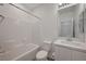 Clean bathroom features a tub-shower combo, toilet, and vanity with quartz countertop and modern fixtures at 6261 Dolosonte St, Las Vegas, NV 89113