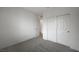Minimalist bedroom showcasing plush carpeting, closet with white sliding doors, and a neutral paint scheme at 6261 Dolosonte St, Las Vegas, NV 89113