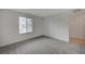 Bedroom featuring gray carpet, white walls and a window with a view at 6261 Dolosonte St, Las Vegas, NV 89113