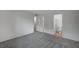 Bedroom featuring gray carpet, white walls, and an ensuite bathroom at 6261 Dolosonte St, Las Vegas, NV 89113