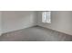 Bedroom featuring gray carpet, white walls and a window with a view at 6261 Dolosonte St, Las Vegas, NV 89113