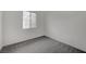 Bedroom featuring gray carpet, white walls and a window with blinds at 6261 Dolosonte St, Las Vegas, NV 89113