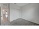 Bright bedroom features plush carpeting, closet with sliding doors, and an open doorway to living space at 6261 Dolosonte St, Las Vegas, NV 89113