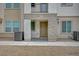 Inviting townhome entrance featuring stone accents, a porch, and desert landscaping at 6261 Dolosonte St, Las Vegas, NV 89113