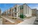 Modern townhome exteriors with stucco, stone accents, small balconies, and desert landscaping in front at 6261 Dolosonte St, Las Vegas, NV 89113
