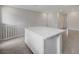 Bright kitchen featuring an island with quartz countertops and modern finishes, and neutral tile flooring at 6261 Dolosonte St, Las Vegas, NV 89113