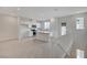Open concept kitchen with white cabinetry, stainless appliances, and island with seating at 6261 Dolosonte St, Las Vegas, NV 89113