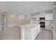 Open floor plan kitchen featuring an island with quartz countertops, stainless steel appliances, and recessed lighting at 6261 Dolosonte St, Las Vegas, NV 89113