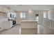 Bright kitchen with white cabinets, stainless steel appliances, and a kitchen island at 6261 Dolosonte St, Las Vegas, NV 89113