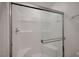 Shower featuring glass doors, tiled walls, and built-in seat at 6261 Dolosonte St, Las Vegas, NV 89113