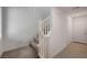 Carpeted stairway with white banister and doorway for a modern home at 6261 Dolosonte St, Las Vegas, NV 89113