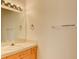 Bathroom featuring a vanity with wood cabinets and a sink with modern fixtures at 7337 Tealwood St, Las Vegas, NV 89131