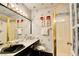 Bathroom featuring updated sink, framed mirror, and glass shower door at 750 S Royal Crest Cir # 346, Las Vegas, NV 89169