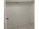 Walk-in closet includes tile floors and one upper shelf with rod for hanging clothes at 7728 Barbican Ct, Las Vegas, NV 89147