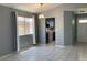 Open-concept dining area with view to the kitchen, light fixture, and natural lighting at 7728 Barbican Ct, Las Vegas, NV 89147