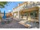 Charming backyard with brick flooring, featuring a dining area, grill, and scenic views of the house at 7778 Villa Montara St, Las Vegas, NV 89123