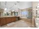 Beautiful bathroom featuring double sinks, a bath tub, and a shower at 7778 Villa Montara St, Las Vegas, NV 89123