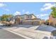Beautiful two-story home with a three car garage, stone accents, and a spacious driveway at 7778 Villa Montara St, Las Vegas, NV 89123