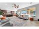 Spacious living area showcasing neutral decor, hardwood floors, large windows, and connection to the kitchen at 7778 Villa Montara St, Las Vegas, NV 89123