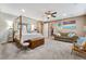 Bright main bedroom featuring a four poster bed and a couch at 7778 Villa Montara St, Las Vegas, NV 89123